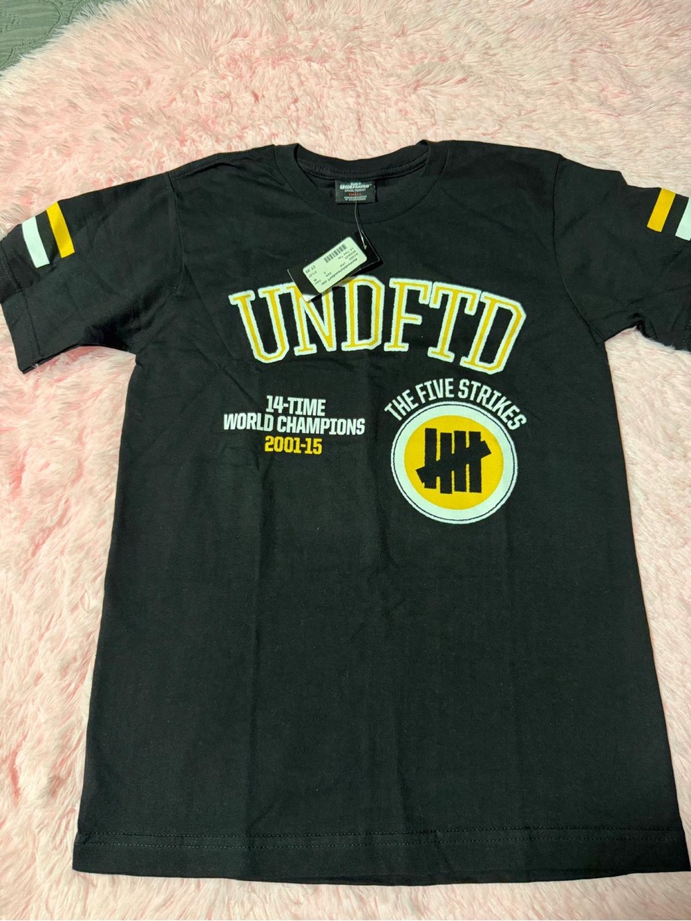 Undefeated Black Graphic Tee with Yellow & White Accents